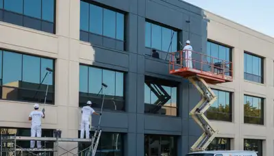 Professional commercial painters working on an office exterior in Burlington, VT